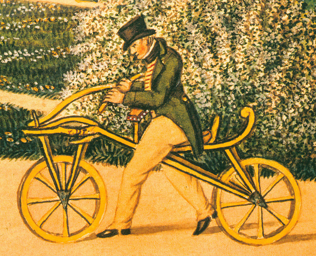 Karl von Drais na svém původním vynálezu v roce 1819. Zdroj: Wikipedia